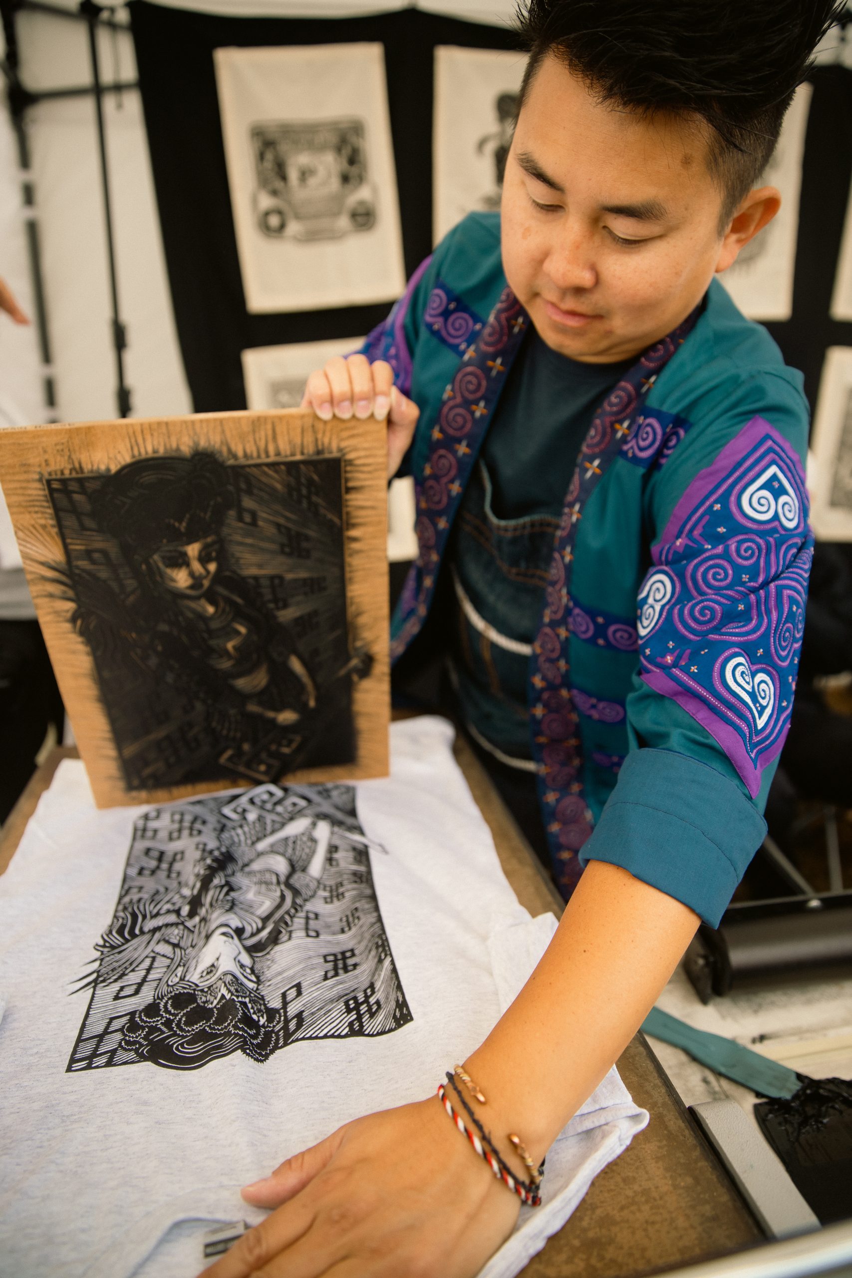 Musician sits in profile with guitar resting on lap.
