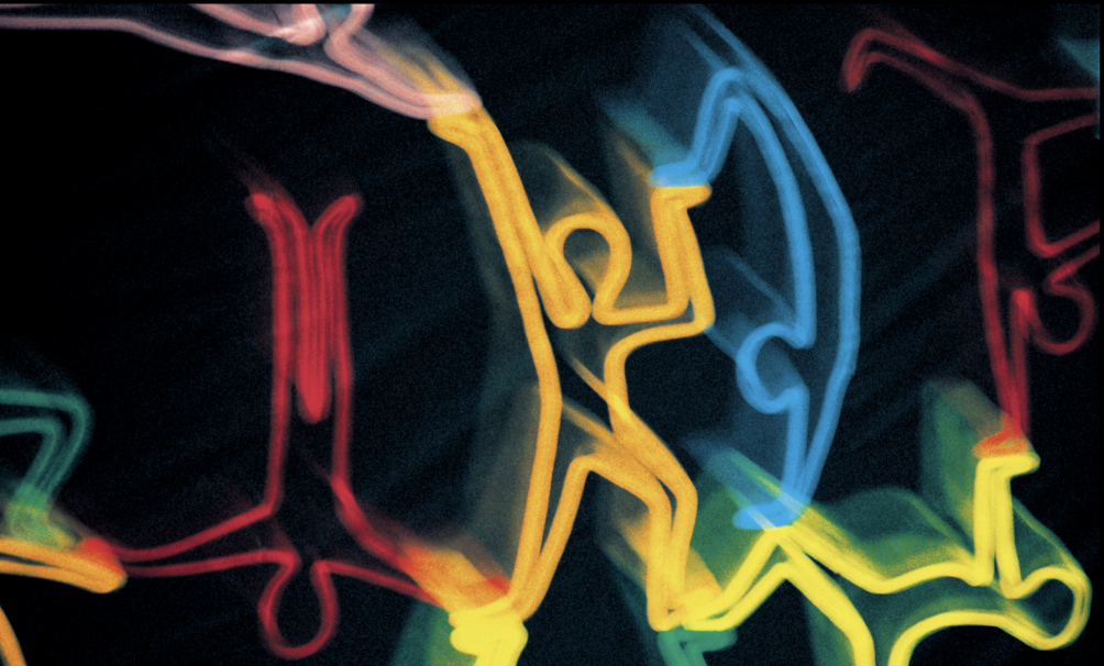 Musician sits in profile with guitar resting on lap.